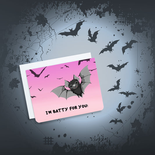 A photo of a pink valentines card with a cartoon bat on it. Text on card reads 'I'm batty for you!'