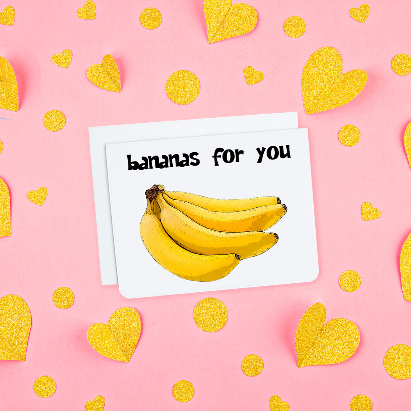 A photo of a white valentines card. It has an image of bananas on it. Text on card reads, 'bananas for you.'