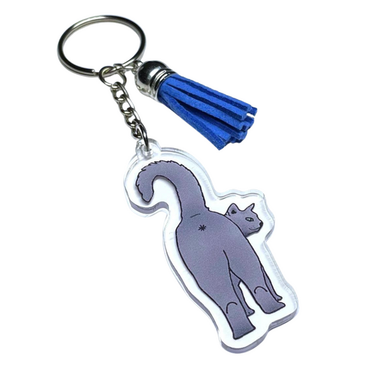 A photo of a funny keychain. It has a grey cat on it showing its butt.