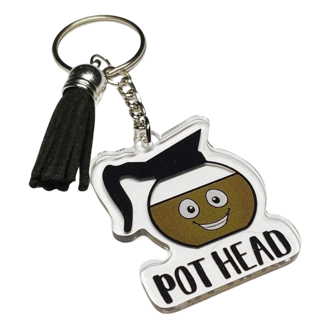 A photo of a funny keychain. It has a cartoon coffee pot on it. Text reads, 'Pot Head.'