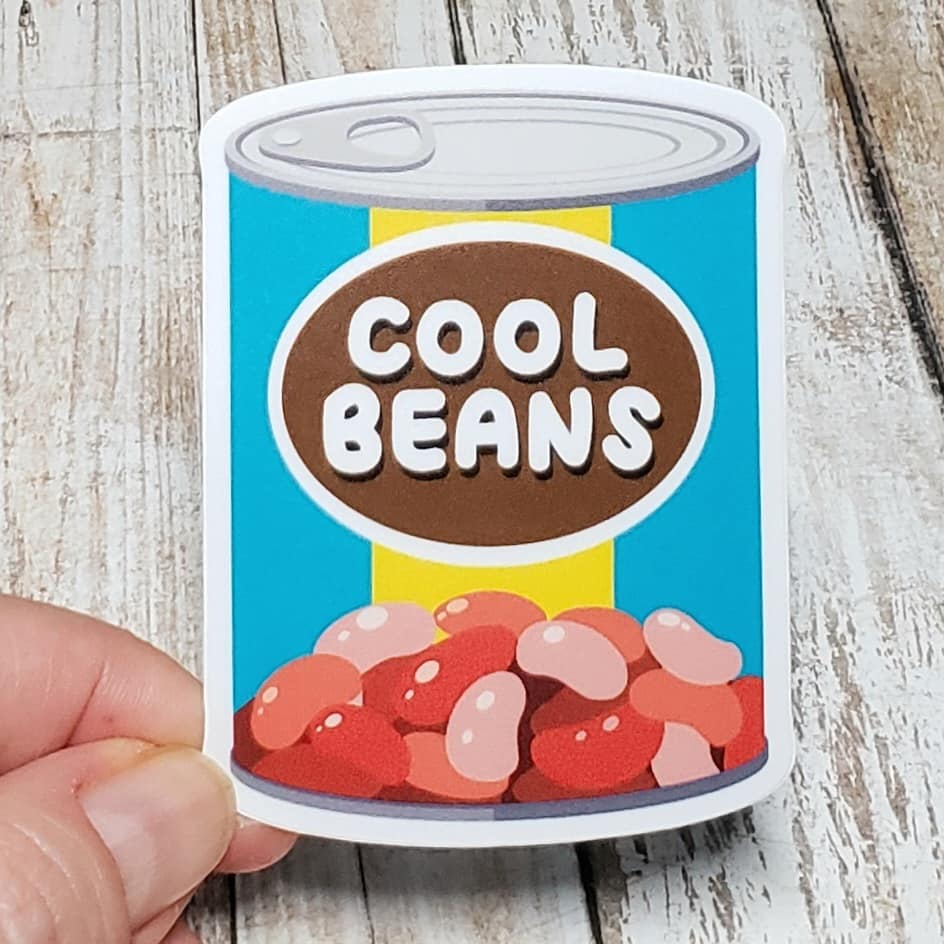 A photo of a fun sticker. It's an illustration of a can of beans. Text on the can label says 'Cool Beans.'