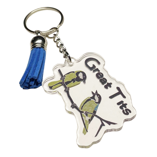 A photo of a vinyl keychain. It has 2 blue birds on it. Text reads, Great Tits.