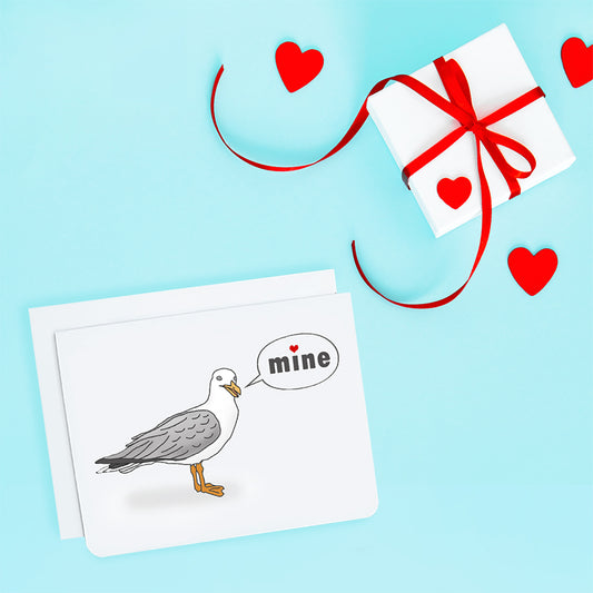 A photo of a white card. It has a cartoon seagull on it. Text on card reads 'Mine.'