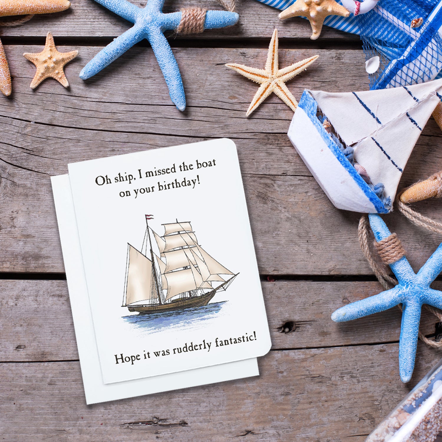 A photo of a white birthday card. It has an illustration of a tall ship on it. Text on card says, 'Oh Ship, I missed the boat on your birthday! Hope it was rudely fantastic!'