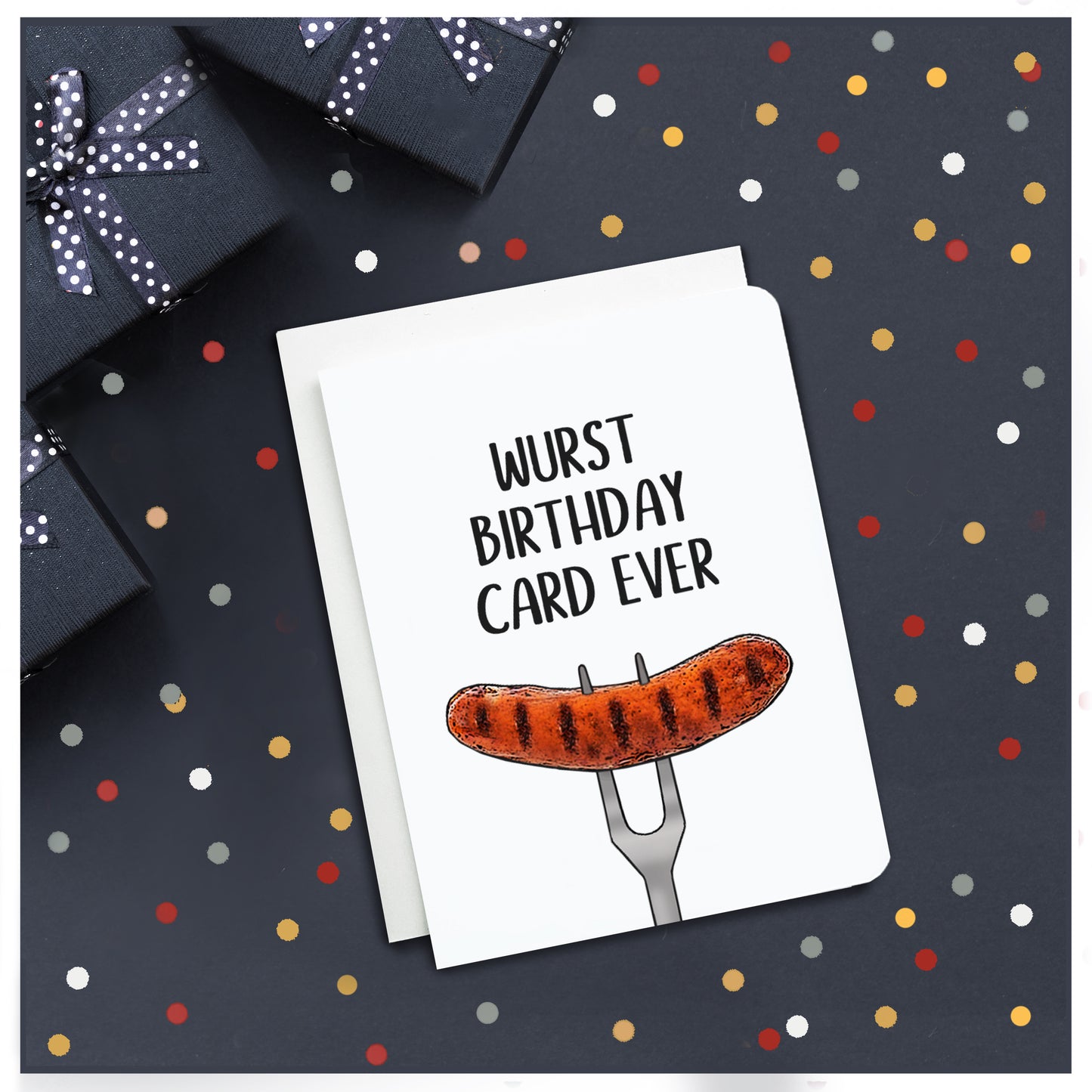 A photo of a white birthday card. It has an illustration of a sausage on a fork on it. Text on card reads, 'Wurst Birthday Card Ever.'