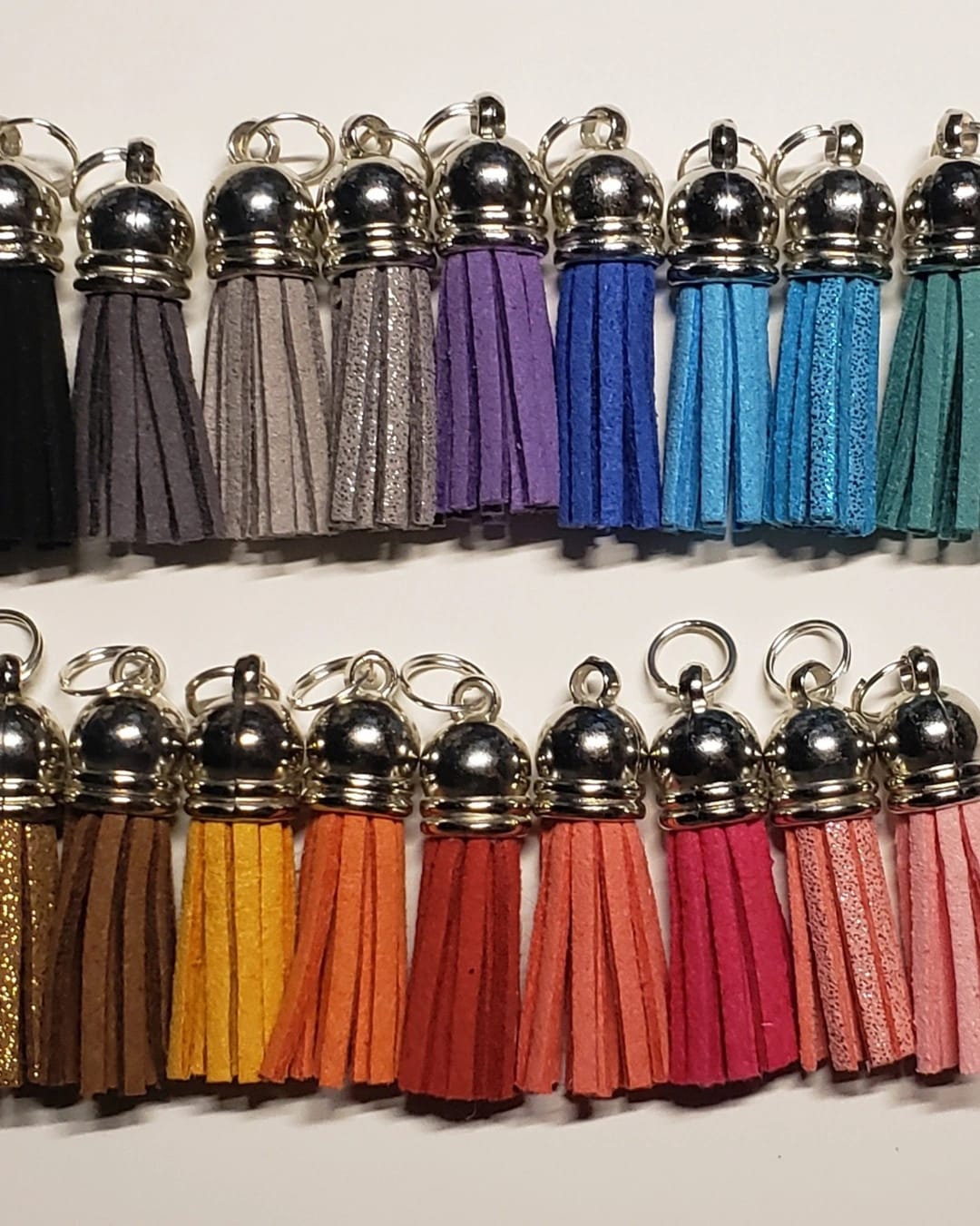 A photo of a lot of different coloured tassels.