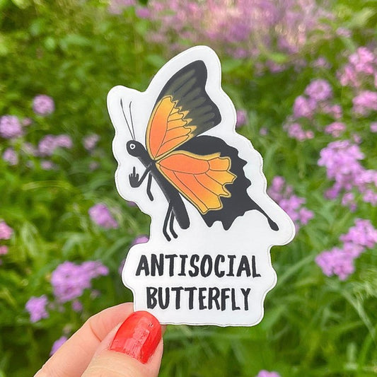 A photo of a vinyl sticker of cartoon monarch butterfly with its finger up. Text on cheeky sticker reads 'Antisocial Butterfly.'