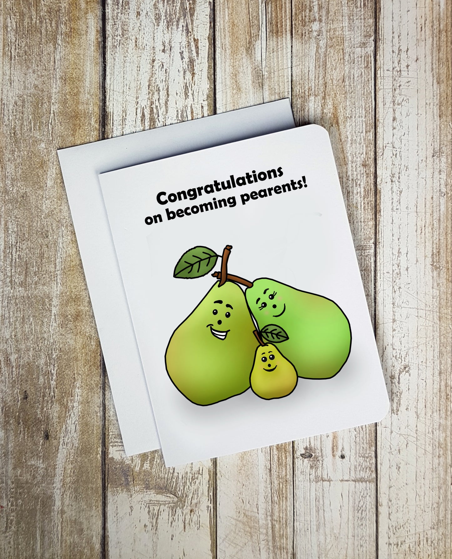 A photo of a baby shower card. It has a two big cartoon pears, and one little pear huddled together. Text one card reads, 'Congratulations on becoming pearents!'