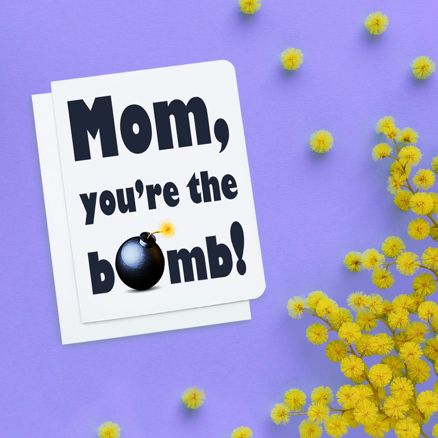 A photo of a Mothers day card. It has bold black text that reads, Mom, you're the bomb. The 'O' of bomb is a bomb.