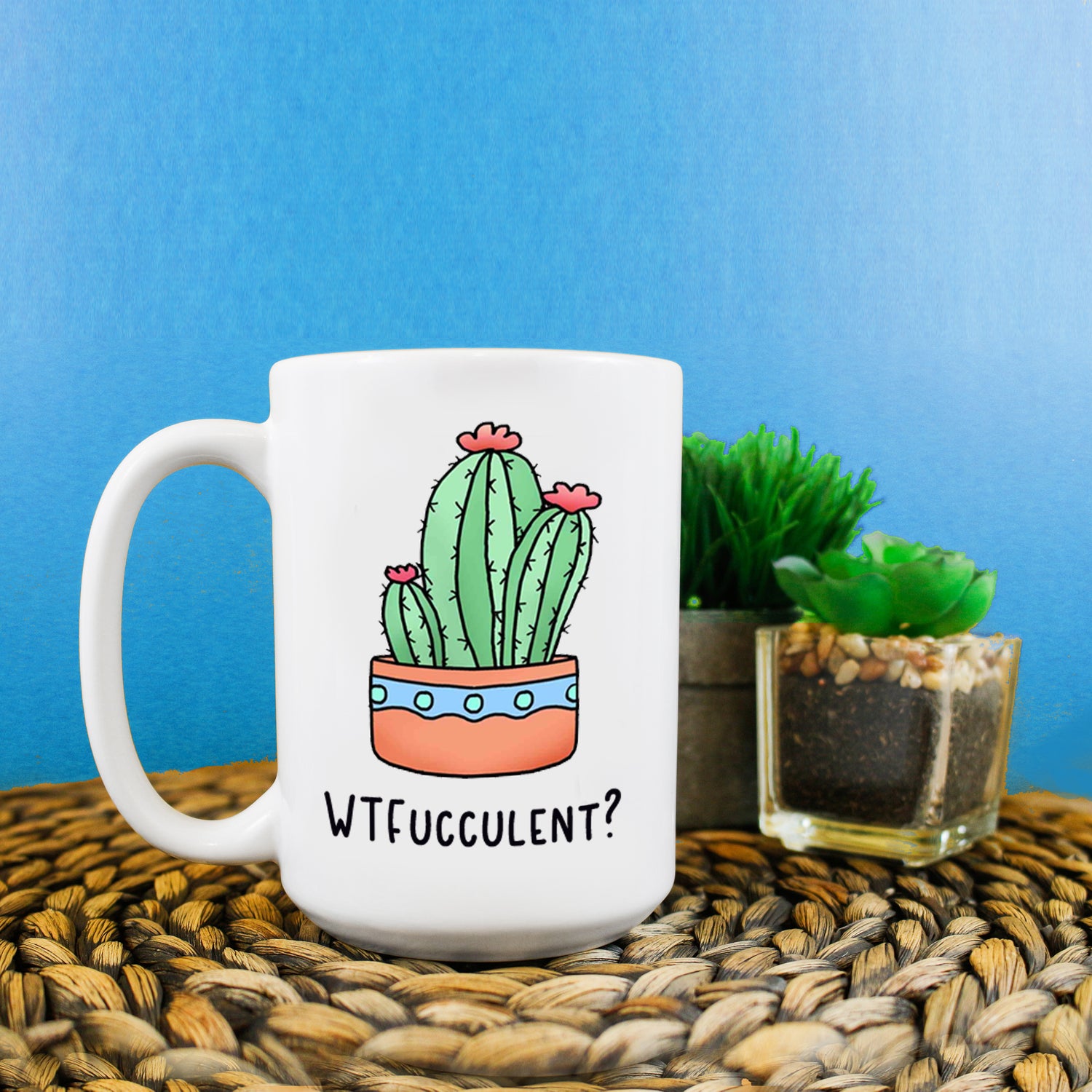 A photo of a funny mug. It has a cartoon succulent on it. Text on mug reads 'WTFucculent?'
