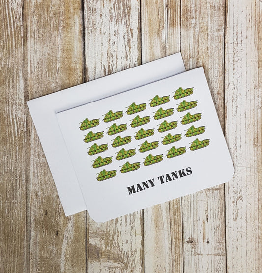 A photo of a white thank you card. It has lots of cartoon tanks on it. Text on card reads, 'Many Tanks.'